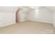 Spacious bonus room with plush carpet and arched window at 3624 Ramsey Rd, Sharon, SC 29742