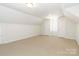 Versatile bonus room featuring neutral carpeting, dormer windows, and ample room for various activities and storage at 3624 Ramsey Rd, Sharon, SC 29742