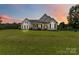 Charming single-Gathering home with a well-manicured lawn and inviting front porch at sunset at 3624 Ramsey Rd, Sharon, SC 29742