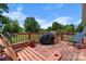 Back deck featuring a covered grill, seating, and lush green backyard at 3651 16Th Ne St, Hickory, NC 28601