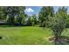 Spacious backyard featuring lush green grass and mature trees at 3651 16Th Ne St, Hickory, NC 28601
