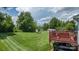 Large backyard with a deck, mature trees and storage buildings at 3651 16Th Ne St, Hickory, NC 28601