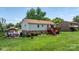 Home exterior featuring a large backyard with pavilion, deck, and established landscaping at 3651 16Th Ne St, Hickory, NC 28601