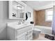 Bathroom features a white vanity, ample lighting, and shower-tub combination at 3651 16Th Ne St, Hickory, NC 28601