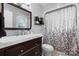Well-lit bathroom with a modern vanity, toilet, and shower, featuring a patterned curtain and contemporary fixtures at 3651 16Th Ne St, Hickory, NC 28601