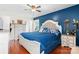 Elegant bedroom featuring a blue accent wall, hardwood floors, and a comfortable bed, creating a cozy retreat at 3651 16Th Ne St, Hickory, NC 28601