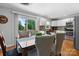 Bright dining area featuring a wooden table, patterned chairs, and natural light, adjacent to a well-lit kitchen at 3651 16Th Ne St, Hickory, NC 28601