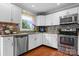 Well-lit kitchen with stainless steel appliances, granite countertops, and stylish backsplash, offering a modern cooking space at 3651 16Th Ne St, Hickory, NC 28601