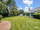 Spacious backyard featuring a storage shed, mature trees, and a well-maintained lawn at 3720 Winterberry Nw Ct, Concord, NC 28027