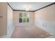 Dining room with wainscoting, carpet, and a large window with shutter-style blinds at 3720 Winterberry Nw Ct, Concord, NC 28027