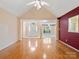 Open-concept living room featuring hardwood floors, high ceilings, and access to other living areas at 3720 Winterberry Nw Ct, Concord, NC 28027