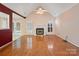 Spacious living room featuring a fireplace, hardwood floors, and lots of natural light at 3720 Winterberry Nw Ct, Concord, NC 28027