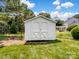 Backyard shed with double doors, offering convenient storage space and well-maintained lawn at 3720 Winterberry Nw Ct, Concord, NC 28027