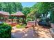 Expansive backyard featuring a hot tub, gazebo, a patio area with seating, mature trees, and a playground at 3889 Mattingly Dr, Hickory, NC 28602