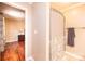 Bathroom with walk-in shower and hardwood floors, with decorative towel rack at 3889 Mattingly Dr, Hickory, NC 28602