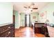 Bright bedroom with hardwood floors, ceiling fan, and a whimsical tree decal on the wall at 3889 Mattingly Dr, Hickory, NC 28602