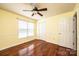 Bright bedroom featuring hardwood floors, a ceiling fan, and natural light from windows at 3889 Mattingly Dr, Hickory, NC 28602