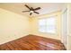 Bright bedroom featuring hardwood floors, a ceiling fan, and natural light from windows at 3889 Mattingly Dr, Hickory, NC 28602