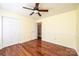 Bright bedroom featuring hardwood floors, a ceiling fan, a closet and an ensuite bathroom at 3889 Mattingly Dr, Hickory, NC 28602