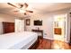 Cozy bedroom featuring hardwood floors, a ceiling fan, and an ensuite bathroom at 3889 Mattingly Dr, Hickory, NC 28602