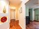 Hallway view featuring hardwood floors, art niches, and a glimpse into an adjacent bedroom at 3889 Mattingly Dr, Hickory, NC 28602