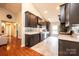 Kitchen showcasing granite counters, tiled backsplash, stainless steel appliances, and dark wood cabinetry at 3889 Mattingly Dr, Hickory, NC 28602