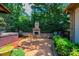Outdoor patio area featuring a stone fireplace, seating, and a covered hot tub, perfect for relaxation and entertainment at 3889 Mattingly Dr, Hickory, NC 28602
