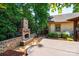 Outdoor patio area with a stone fireplace, seating, and a covered hot tub, perfect for relaxation and entertainment at 3889 Mattingly Dr, Hickory, NC 28602