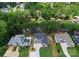 Stunning aerial view of a lakeside home surrounded by lush greenery and neighboring residences, highlighting its prime location at 4069 Rivendell Rd, Denver, NC 28037