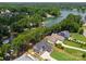 Breathtaking aerial shot of a home nestled by a serene lake, surrounded by trees, showcases its idyllic setting at 4069 Rivendell Rd, Denver, NC 28037