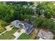 An aerial perspective reveals a house with a private pool, long drive, and wooded waterfront access at 4069 Rivendell Rd, Denver, NC 28037