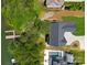 Aerial view of a home featuring a pool and lakeside access, surrounded by lush greenery, creating a private oasis at 4069 Rivendell Rd, Denver, NC 28037