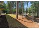 Expansive backyard with lush greenery and mature trees, leading to a serene lake with a private dock at 4069 Rivendell Rd, Denver, NC 28037