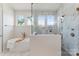 Spa-like bathroom with a freestanding tub, marble shower, and natural light at 4069 Rivendell Rd, Denver, NC 28037