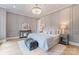 Elegant bedroom features stylish decor, a soft rug, and a dazzling chandelier at 4069 Rivendell Rd, Denver, NC 28037