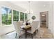 Dining area with large windows, neutral decor, a modern chandelier, and a view into the bedroom at 4069 Rivendell Rd, Denver, NC 28037
