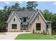 Charming two-story home with a brick and siding facade, set against a backdrop of lush greenery at 4069 Rivendell Rd, Denver, NC 28037