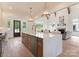 Open-concept kitchen with a large island, pendant lights, stainless steel appliances, and hardwood floors at 4069 Rivendell Rd, Denver, NC 28037