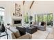Bright living room boasts high ceilings, wooden beams, fireplace, and sliding glass doors to the deck at 4069 Rivendell Rd, Denver, NC 28037
