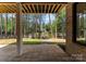 Relax on the stone patio and enjoy the scenic lake view framed by lush greenery, offering a peaceful retreat at 4069 Rivendell Rd, Denver, NC 28037
