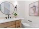 Chic powder room with a wooden vanity, modern fixtures, and stylish mirror at 4069 Rivendell Rd, Denver, NC 28037