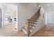 Bright foyer boasts a staircase with wooden steps and iron balusters at 4069 Rivendell Rd, Denver, NC 28037