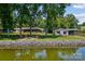 Expansive backyard with a fire pit area, leading to a private lake and boat dock at 4485 River Oaks Rd, Lake Wylie, SC 29710
