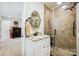 Bathroom featuring a tiled shower with glass door, granite vanity, and warm neutral color palette at 4485 River Oaks Rd, Lake Wylie, SC 29710