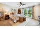 Bedroom showcasing a bed, bedside table with lamp, and large window with scenic views and natural light at 4485 River Oaks Rd, Lake Wylie, SC 29710