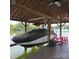 Covered boat lift with modern boat, with a lakeside view perfect for waterfront activities at 4485 River Oaks Rd, Lake Wylie, SC 29710