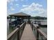 Covered boat dock featuring boat lift, kayak storage, and a swim platform on a calm lake setting at 4485 River Oaks Rd, Lake Wylie, SC 29710
