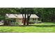 Quaint cottage with a vibrant red door and lush green lawn, offering a cozy, inviting appeal at 4485 River Oaks Rd, Lake Wylie, SC 29710