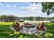 Inviting lakefront fire pit with stone surround and Adirondack chairs perfect for relaxing by the water at 4485 River Oaks Rd, Lake Wylie, SC 29710
