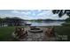 Lakefront property with a cozy fire pit area surrounded by Adirondack chairs, perfect for evening gatherings at 4485 River Oaks Rd, Lake Wylie, SC 29710